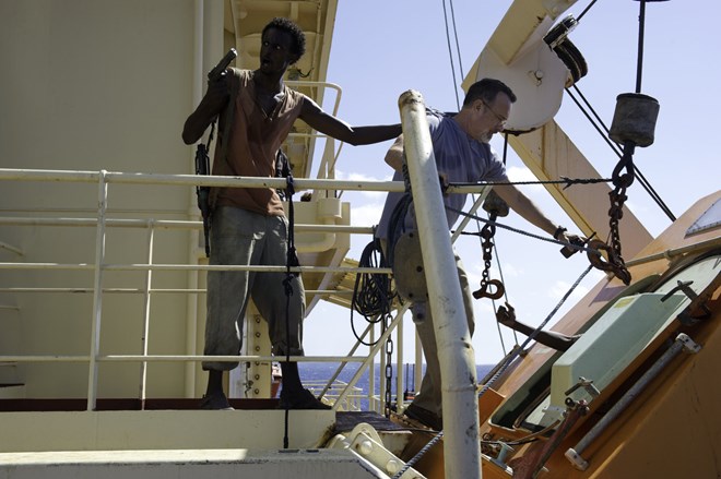 Captain Richard Phillips (Tom Hanks) is escorted by Somali pirates in "Captain Phillips." Jasin Boland / Columbia Pictures